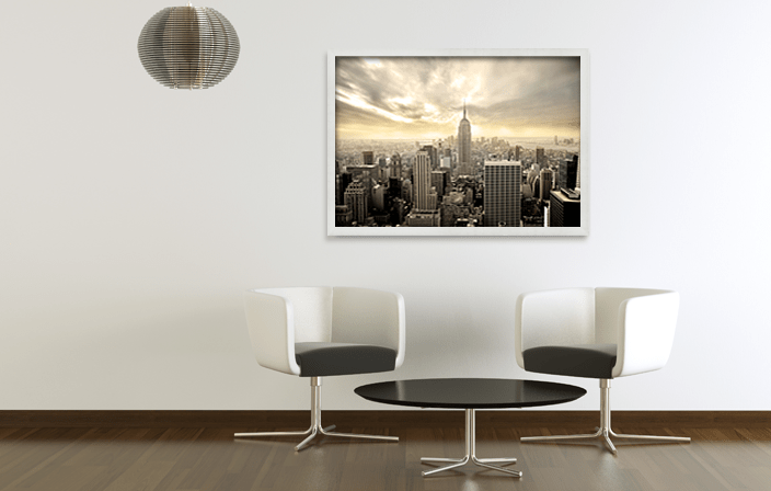 Aluminium Poster Frame Sideloader Modern D710 in silver matt color, with poster of Manhattan, placed in interior of light colors. Picture frame producer Debex Suisse.