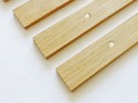 Close-up of wooden bed slats with pre-drilled holes